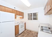 Thumbnail 20 of 30 - A kitchen with white appliances and wooden cabinets.