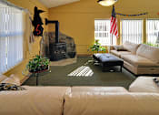 Thumbnail 7 of 42 - A living room with a fireplace and a couch.