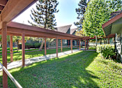 Thumbnail 2 of 42 - A wooden covered walkway with a metal railing.