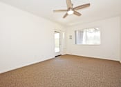 Thumbnail 18 of 42 - Empty room with a ceiling fan and carpeted floor.