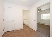 Thumbnail 25 of 42 - A room with white doors and wooden floors.