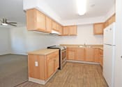 Thumbnail 27 of 42 - A kitchen with wooden cabinets and a white refrigerator.