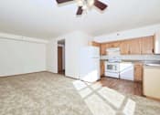 Thumbnail 28 of 29 - A kitchen with white appliances and wooden cabinets.