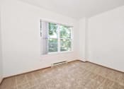 Thumbnail 27 of 29 - A room with a window and a carpeted floor.