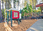 Thumbnail 6 of 30 - A playground with a red and blue structure and a slide.