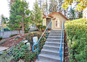 Thumbnail 2 of 30 - A house with a staircase leading to the front door.