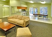 Thumbnail 9 of 30 - A living room with a couch, chairs, and a dining table.