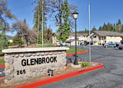 Thumbnail 4 of 12 - A street sign for Glenbrook with a stone base and a red border.