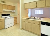 Thumbnail 13 of 17 - A kitchen with a white fridge and a black stove top.