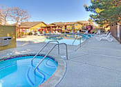 Thumbnail 10 of 17 - A pool with a slide and a fence.