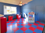 Thumbnail 8 of 17 - A room with a blue wall and a red and blue checkered floor.