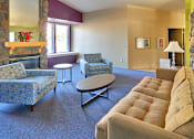 Thumbnail 2 of 17 - A living room with a fireplace and a couch.