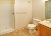 Thumbnail 29 of 41 - A white toilet sits next to a sink in a bathroom.