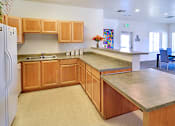 Thumbnail 18 of 41 - A kitchen with wooden cabinets and a white refrigerator.
