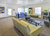 Thumbnail 20 of 41 - A room with a couch, chairs, and a television set.