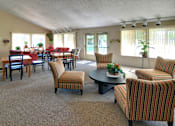 Thumbnail 14 of 35 - A living room with a dining table and chairs.