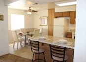 Thumbnail 9 of 16 - A kitchen with a table and chairs.
