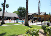 Thumbnail 5 of 16 - A pool surrounded by a fence and trees.