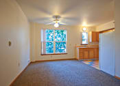 Thumbnail 16 of 29 - A room with a ceiling fan and a window with trees visible outside.