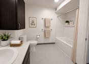 Thumbnail 6 of 10 - A bathroom with a toilet, sink, and a plant.