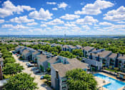 Thumbnail 4 of 25 - A view of a residential area with houses and a swimming pool. at Infinity on the Landing Apartments , Euless, Texas