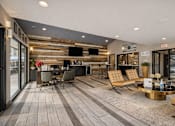 Thumbnail 18 of 25 - A modern living room with a wooden wall and a grey floor. at Infinity on the Landing Apartments , Texas