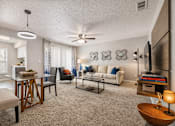 Thumbnail 17 of 25 - A living room with a couch, chairs, and a coffee table. at Infinity on the Landing Apartments , Euless