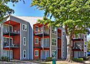 Thumbnail 3 of 25 - A modern apartment building with balconies and multiple stories at Infinity on the Landing Apartments, Euless, TX, 76040