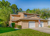 Thumbnail 48 of 74 - A house with a garage and an American flag hanging on it.