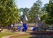 Thumbnail 18 of 74 - A playground with a blue slide and two towers.
