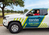 Thumbnail 9 of 37 - A white truck with a blue and green design and the words "Corvias Property Management" on the side is parked on a street.