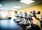 Thumbnail 18 of 37 - A gym with treadmills and exercise bikes.