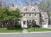 Thumbnail 24 of 37 - A two-story house with a white door and windows.
