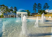 Thumbnail 12 of 74 - A pool with a fountain in the middle of it.