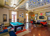 Thumbnail 26 of 74 - A pool table is in the middle of a room with a checkered floor.