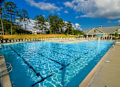 Thumbnail 14 of 74 - A large swimming pool with a building in the background.