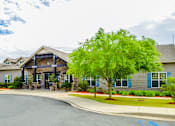 Thumbnail 44 of 74 - A building with a blue sky and clouds in the background.