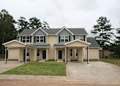 Thumbnail 59 of 74 - A large house with a grey roof and a grey garage door.