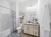 Thumbnail 12 of 69 - A bathroom with a white toilet, sink, and a mirror.
