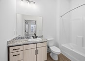 Thumbnail 68 of 69 - A white bathroom with a sink, toilet, and bathtub.