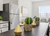 Thumbnail 58 of 69 - A kitchen with a black countertop and a black fridge.