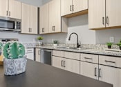 Thumbnail 49 of 69 - A kitchen with a countertop and cabinets.