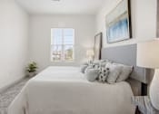 Thumbnail 63 of 69 - A bedroom with a large bed and a painting on the wall.