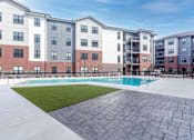 Thumbnail 40 of 69 - A large apartment complex with a pool in the courtyard.