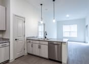Thumbnail 26 of 69 - A kitchen with a granite countertop and stainless steel sink.