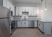 Thumbnail 27 of 69 - A modern kitchen with stainless steel appliances and wooden cabinets.
