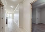 Thumbnail 23 of 25 - A long white hallway with a door on the right.