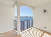 Thumbnail 14 of 25 - A balcony with a view of the water and sky.