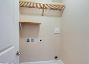 Thumbnail 24 of 25 - A small, empty room with a white door and a white wall.