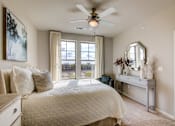 Thumbnail 1 of 36 - A bedroom with a large bed and a ceiling fan.